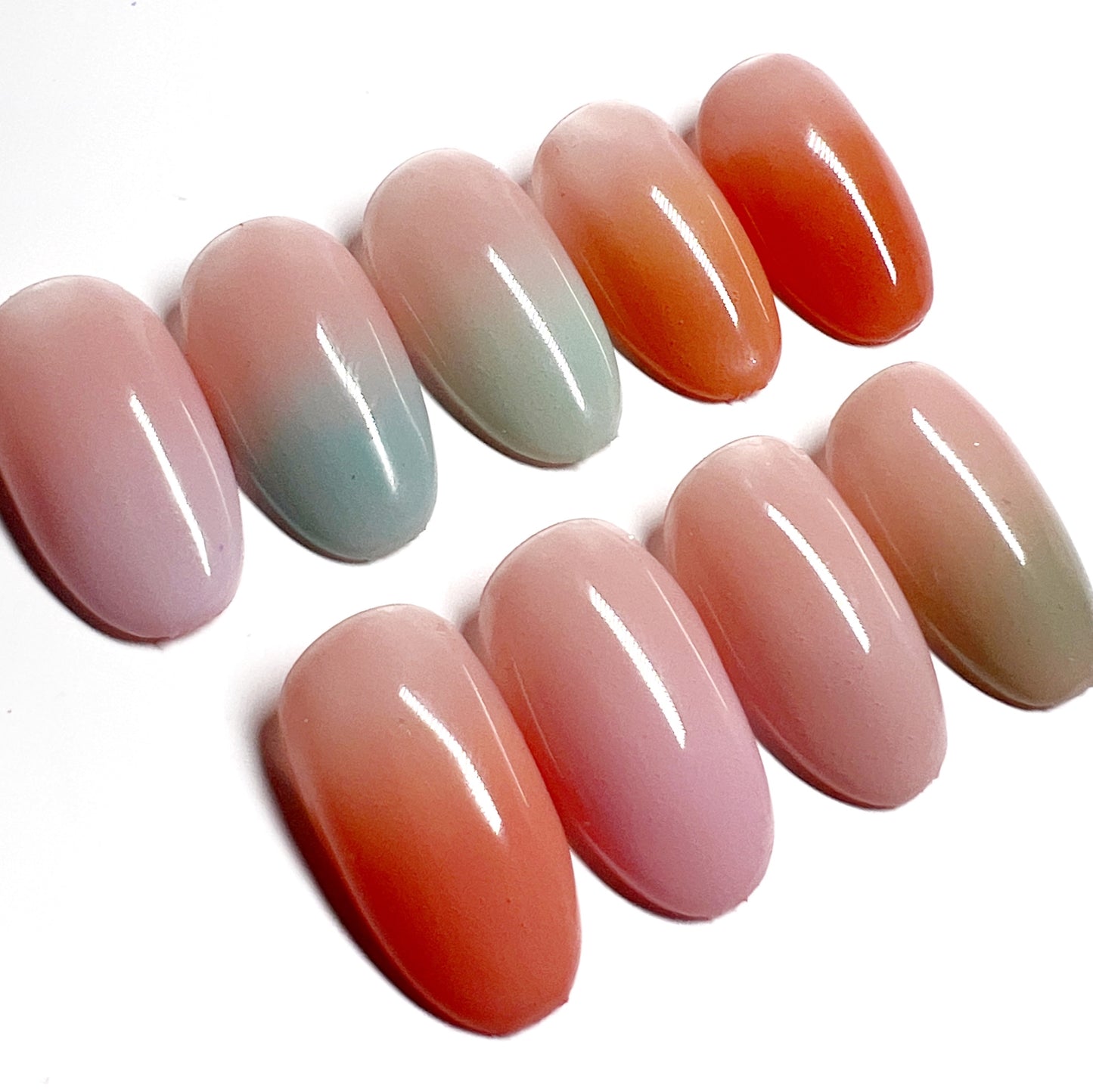 Decorated nail tips on white background.