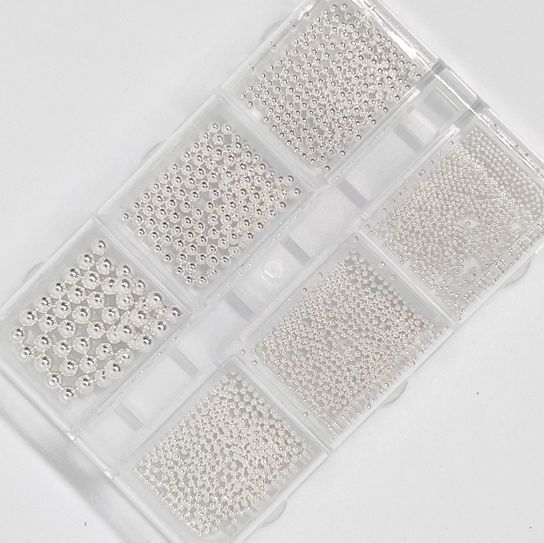 Silver Metal Balls (Caviar) for Nail Art - Aerial View on White Background.
