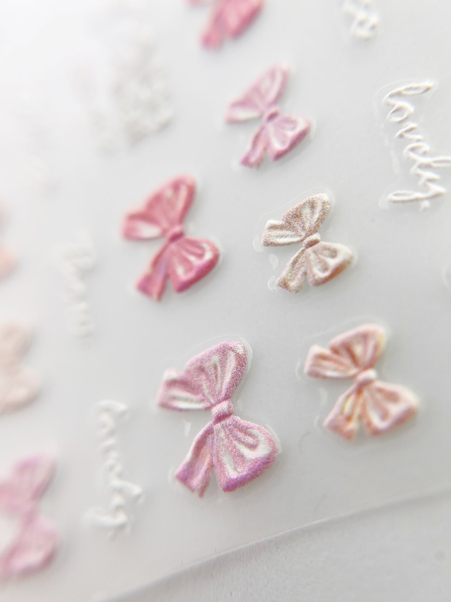 Pink and peach bow embossed nail stickers.