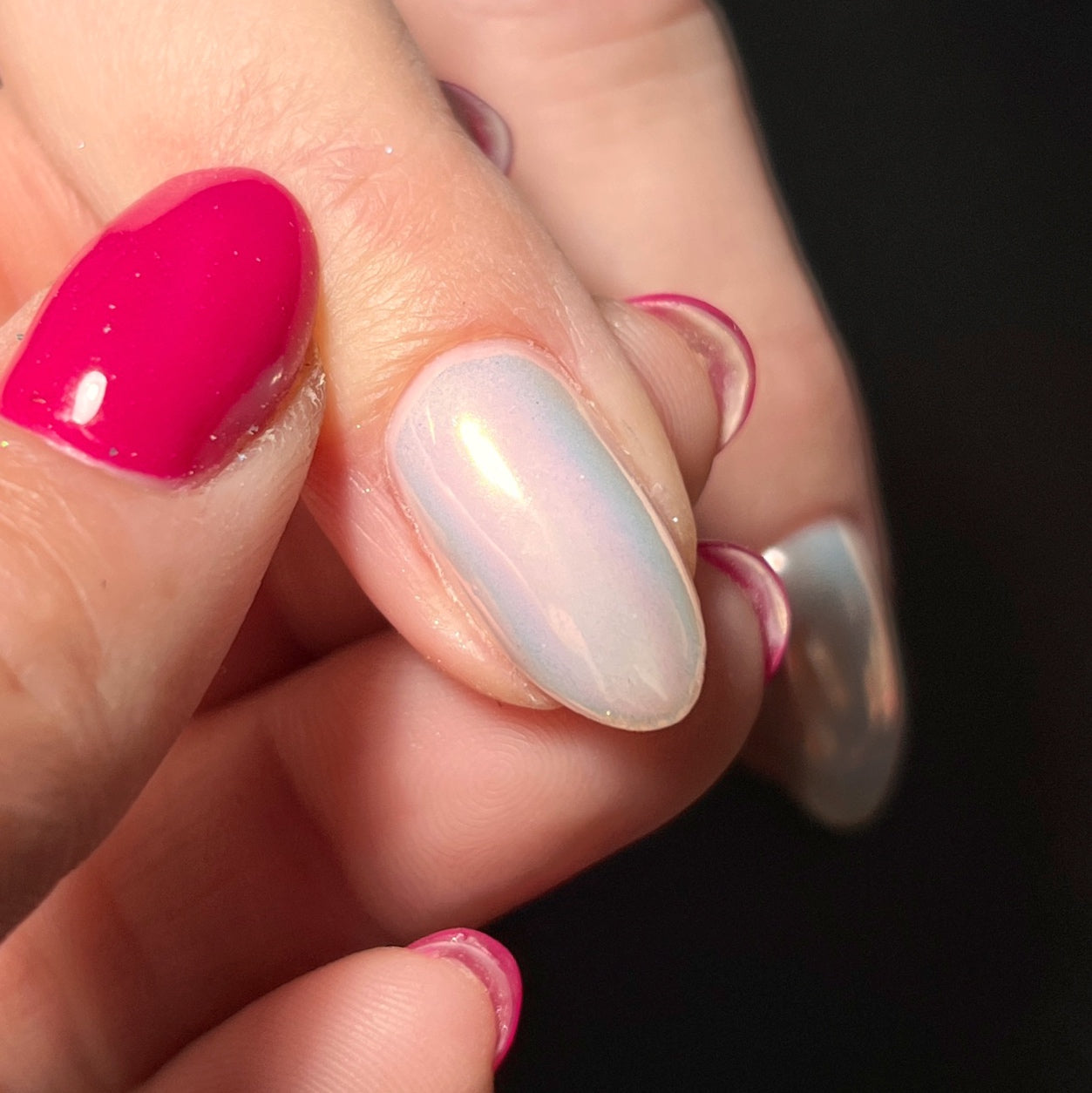 Close up of hand with holding finger on dark background.