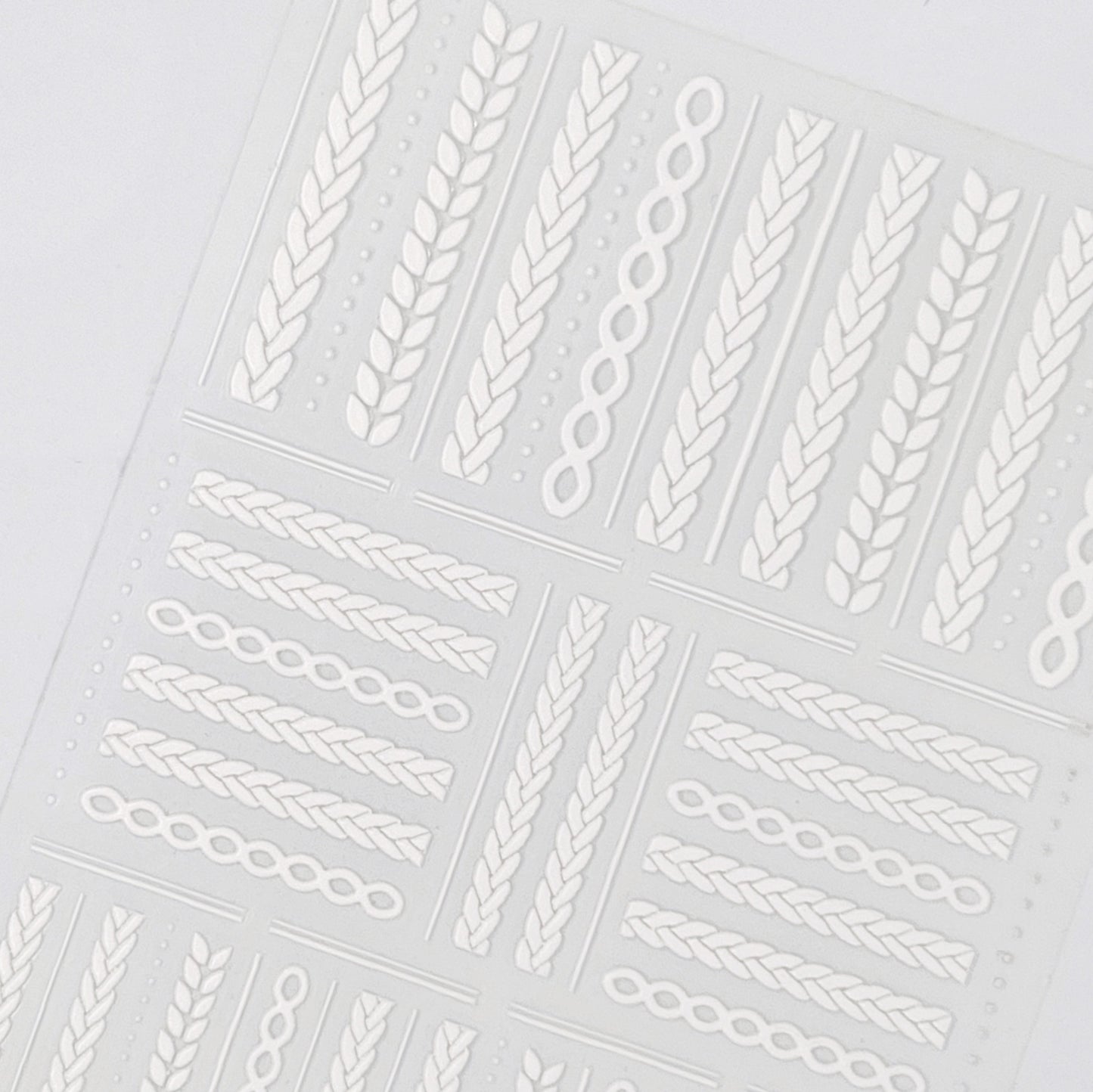 Detailed view of embossed texture white braided stickers.