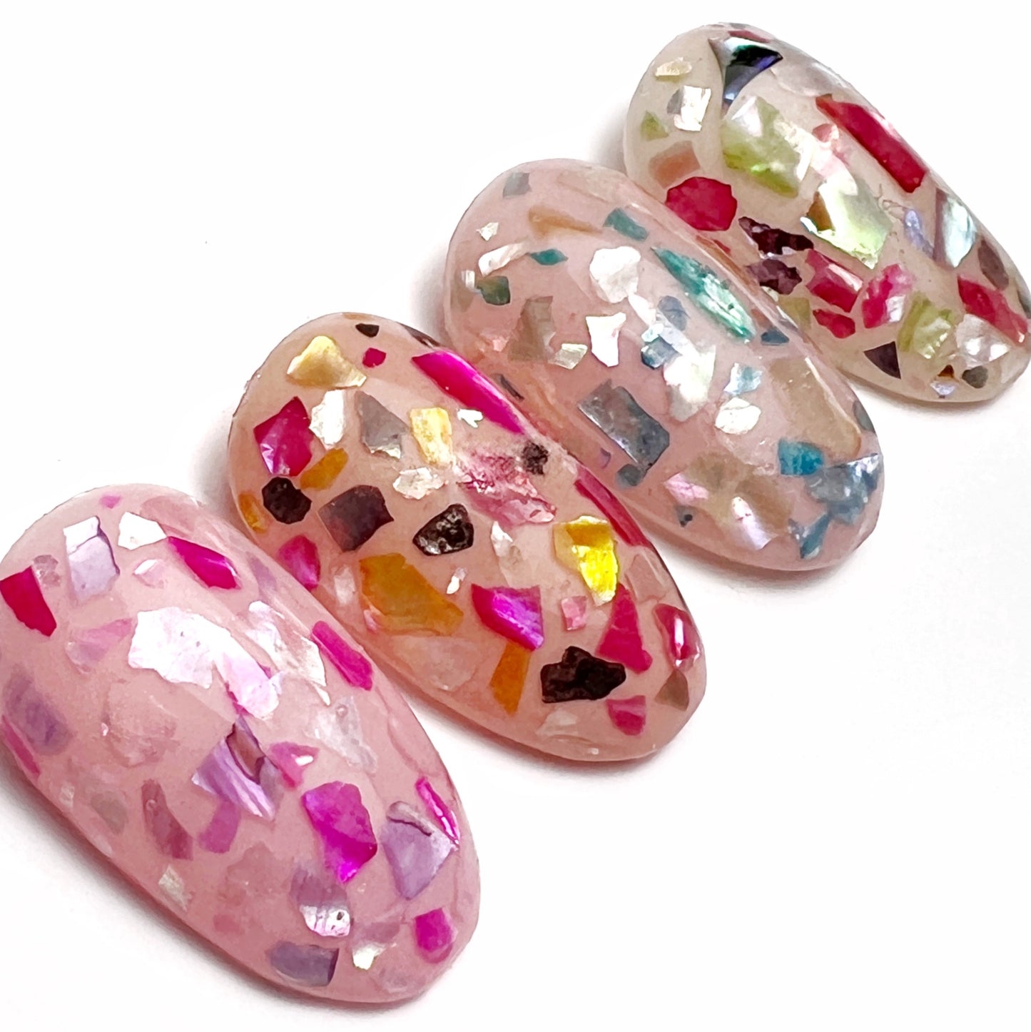 Decorated nail tips on white background.