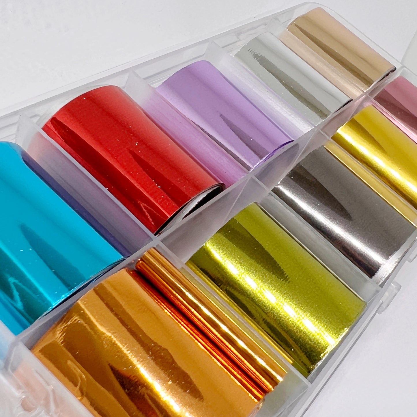 Metallic Foil Set - 10 Solid Metallic Foils in Blue, Red, Purple, Silver, Rose Gold, Copper, Olive, Gunmetal, Gold, and Pink, Presented in a Clear Case on a White Background.