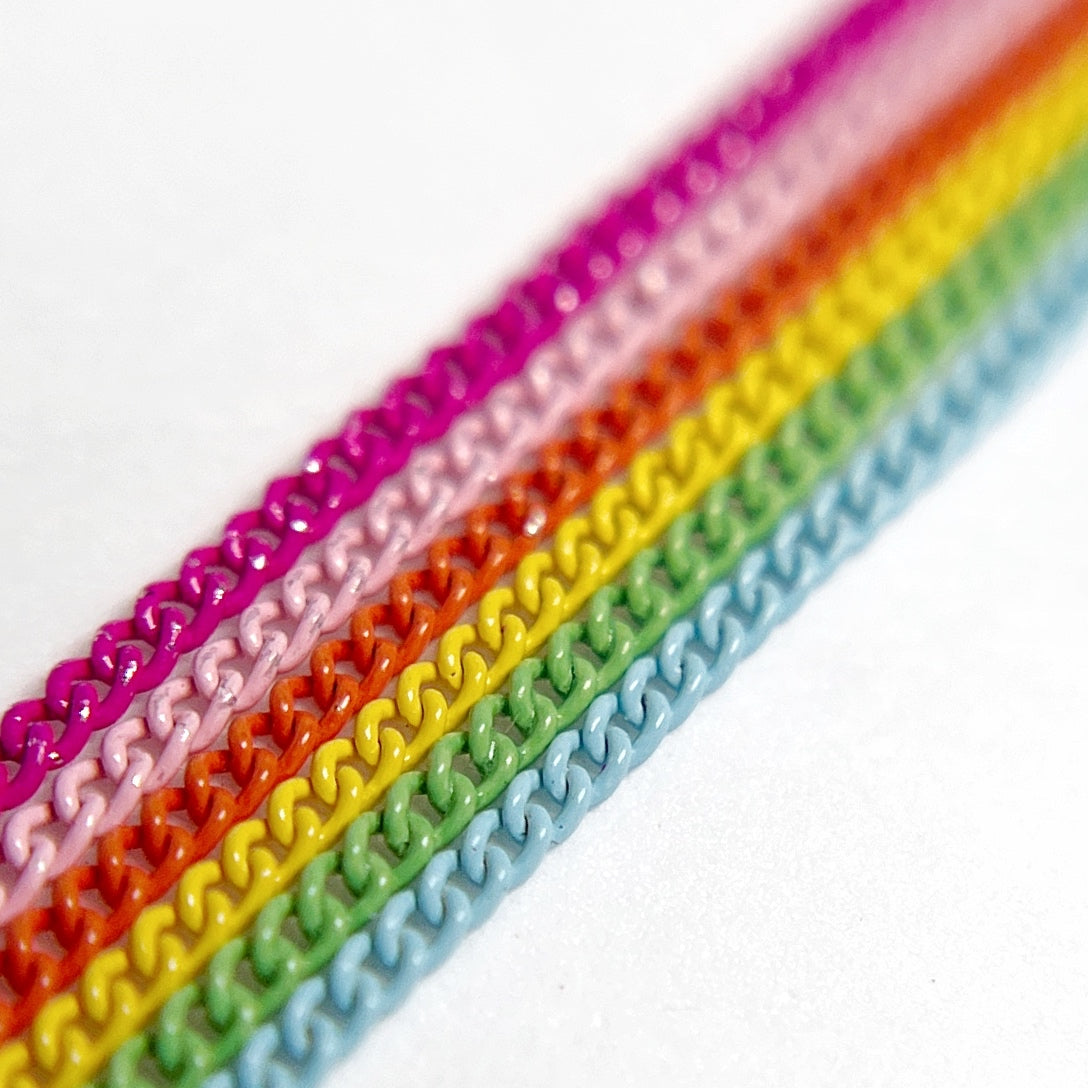Close-Up of Multi-Color Nail Art Chains in vivid tones on White Background.