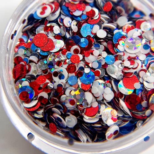 Multicolor circle glitter mix in clear jar on white background.