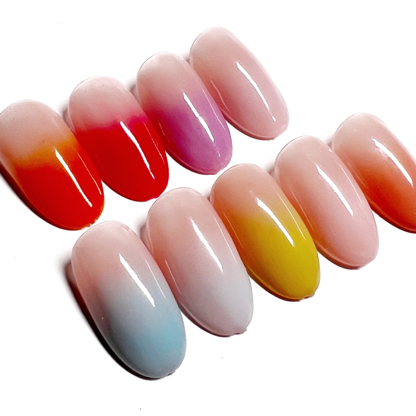 Decorated nail tips on white background.