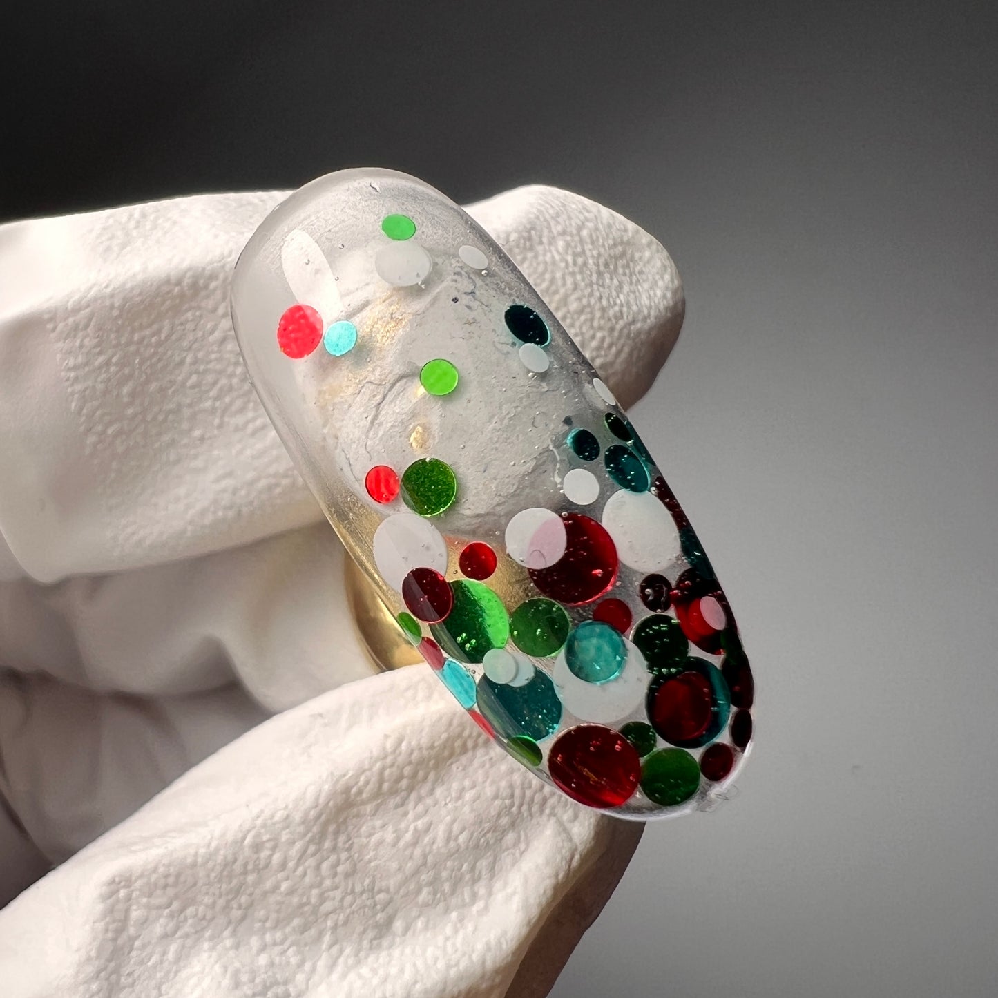 Hand holding decorated nai tip.