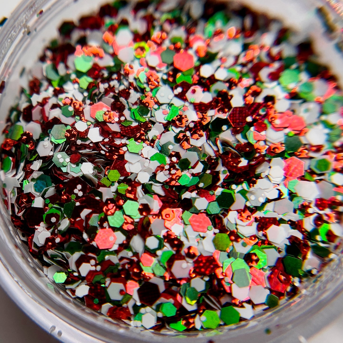 Detailed view of red, green and white hexagon glitter mix.