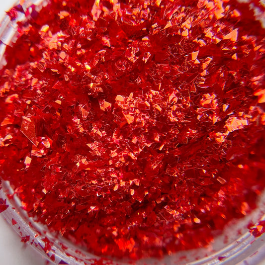 Detailed view of red irregular shaped glitter.