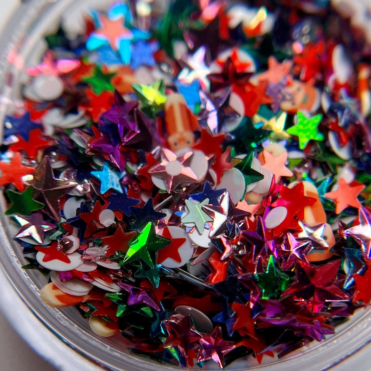 Detail view of glitter in clar jar on white background.