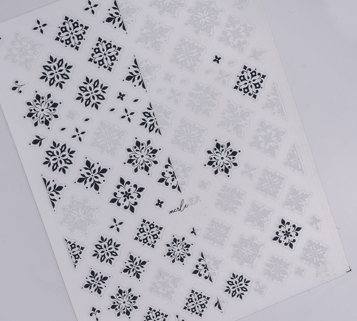 Nail decal sheet with black and white design on white background.