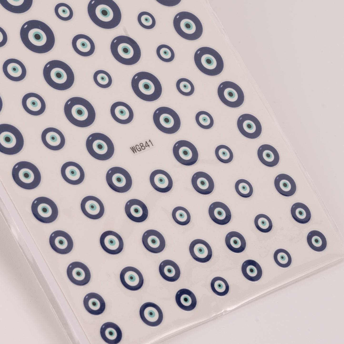 Nail decal sheet with blue eye design on light background.