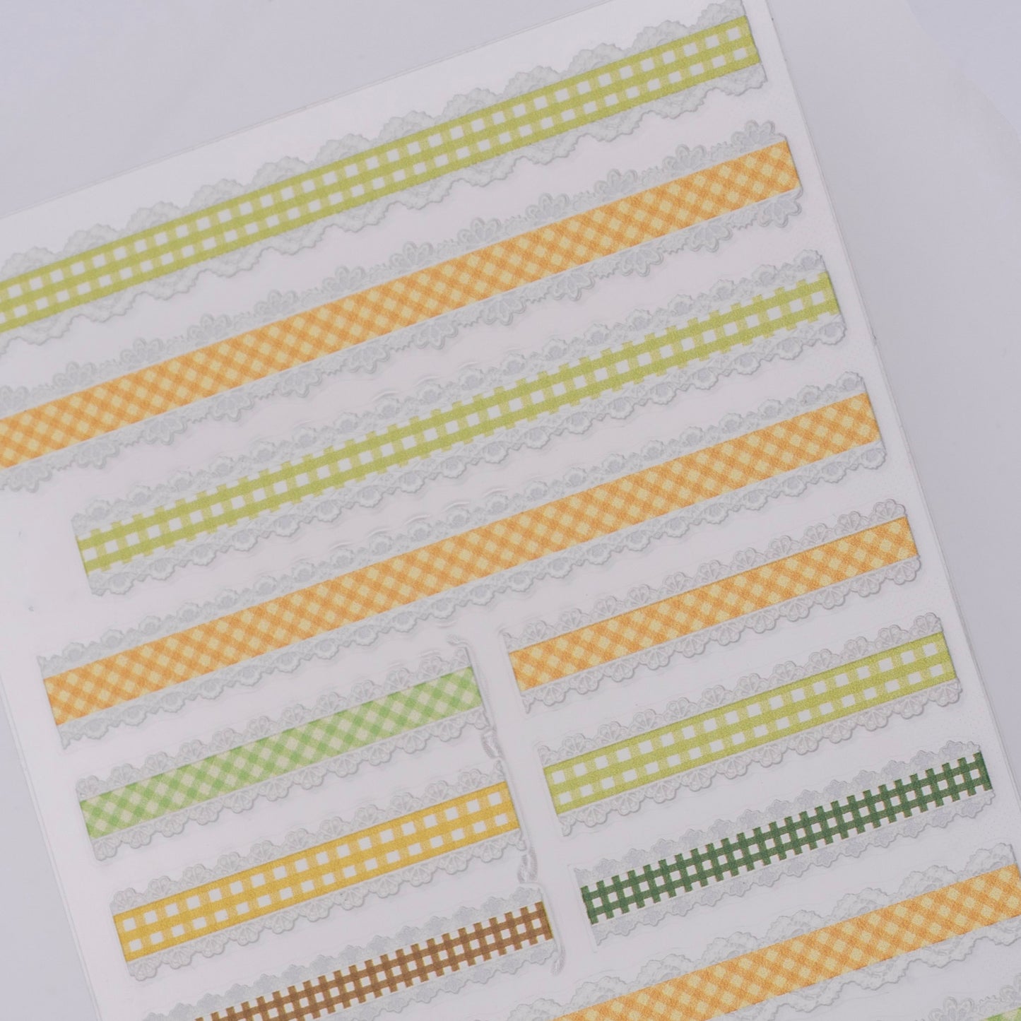 Checker design nail stickers on white background.