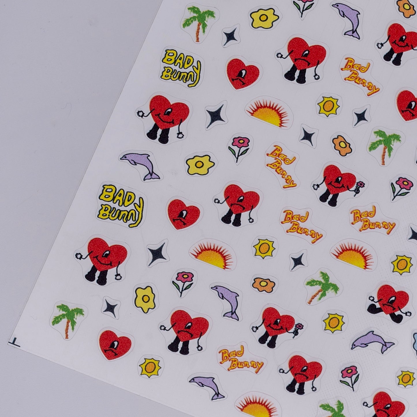 Sheet of stickers with cartoon hearts, flowers, and other designs on a white background.