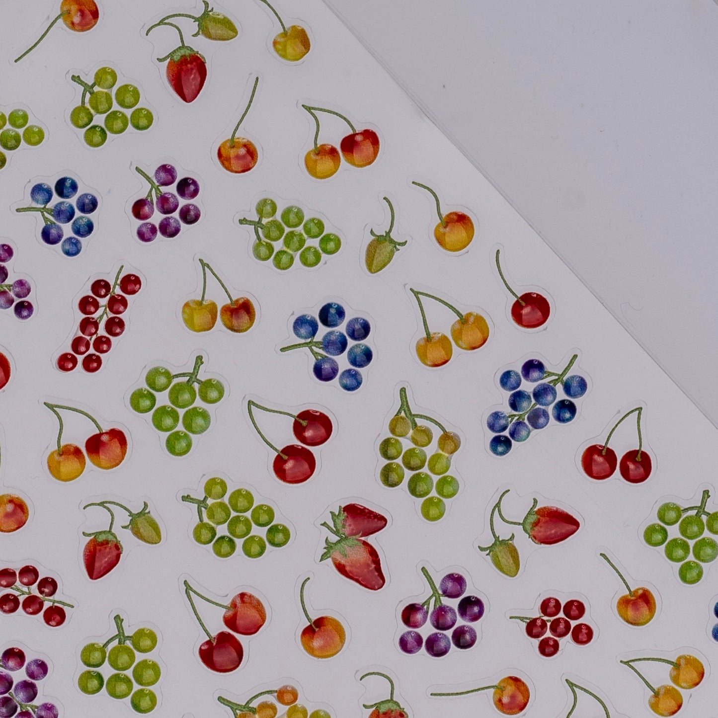 Detail view of nail decal sheet on light background.
