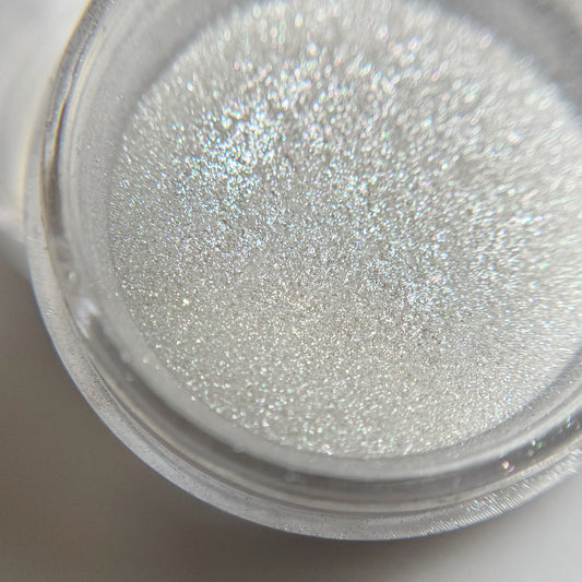 Close up of pigment powder in transparent jar with blurred background