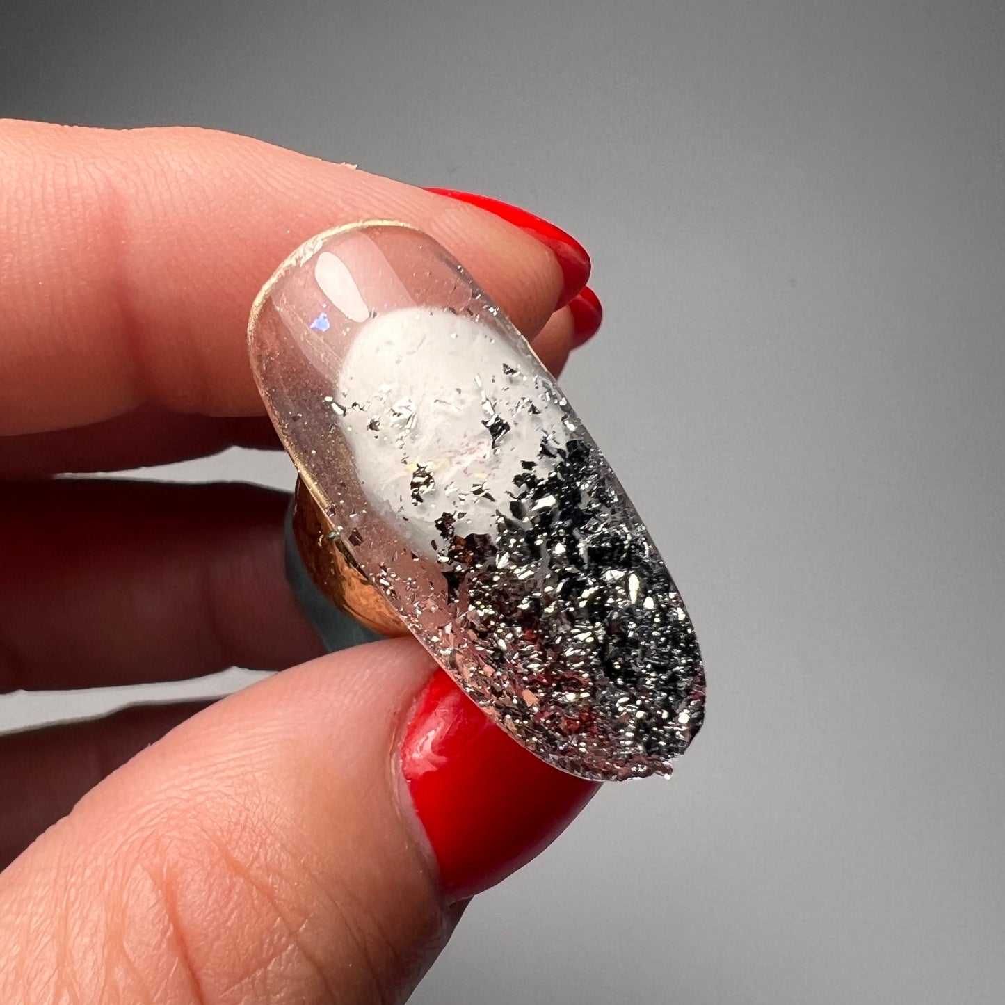 Thin silver foil flakes for nail art.