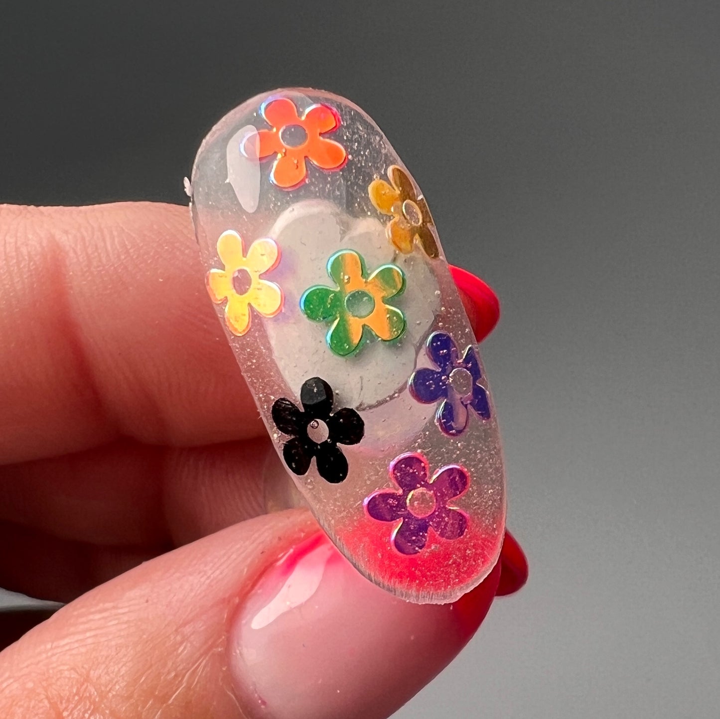 hand holding decorated nail tip