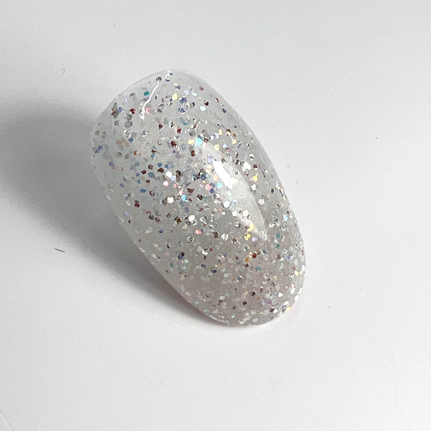 Glitter nail tip swatch on white background.