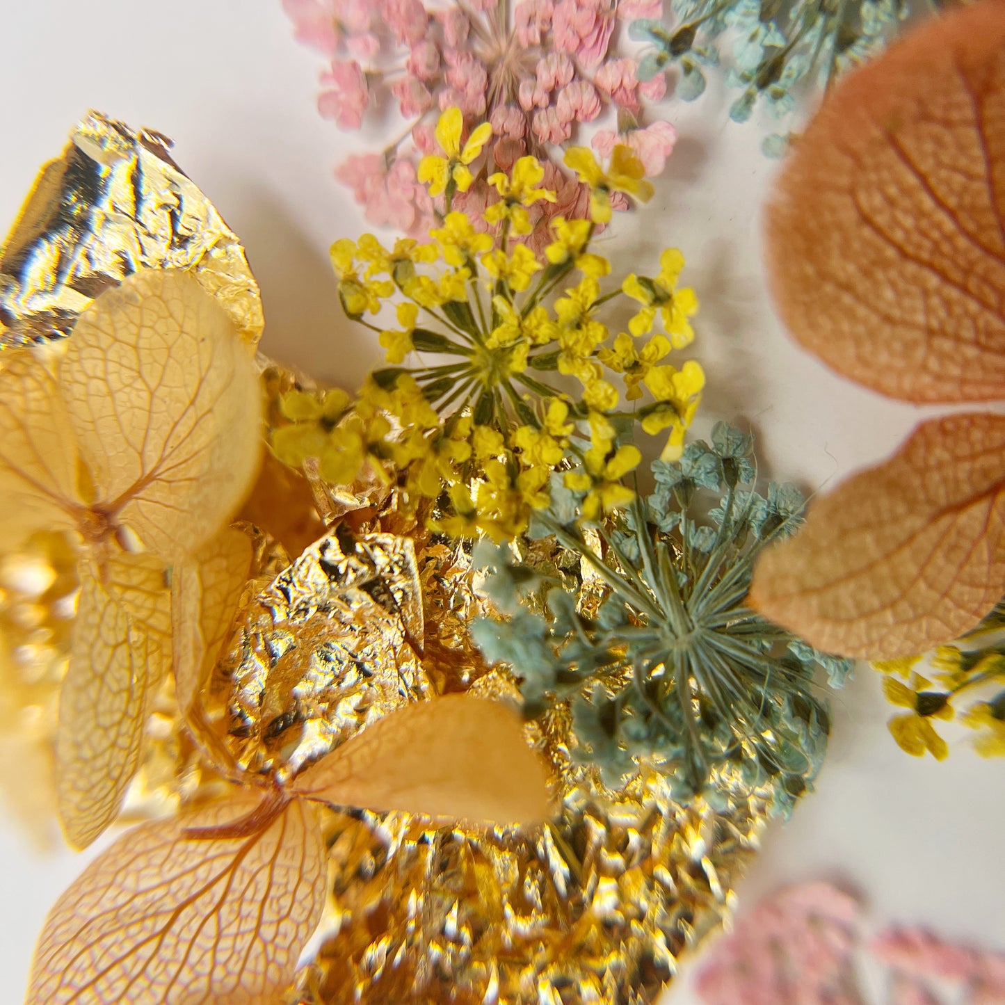 Floral and foil mix on white background.