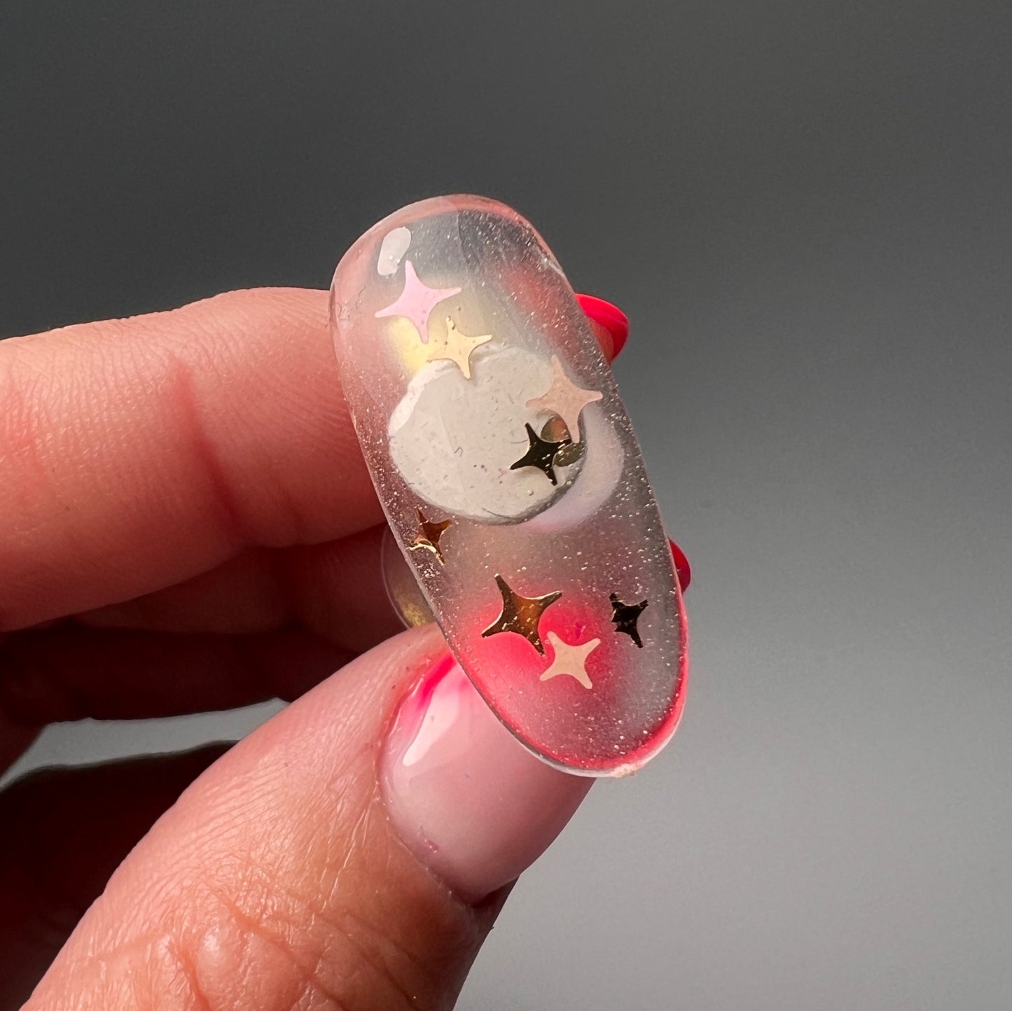 Hand holding decorated nail tip