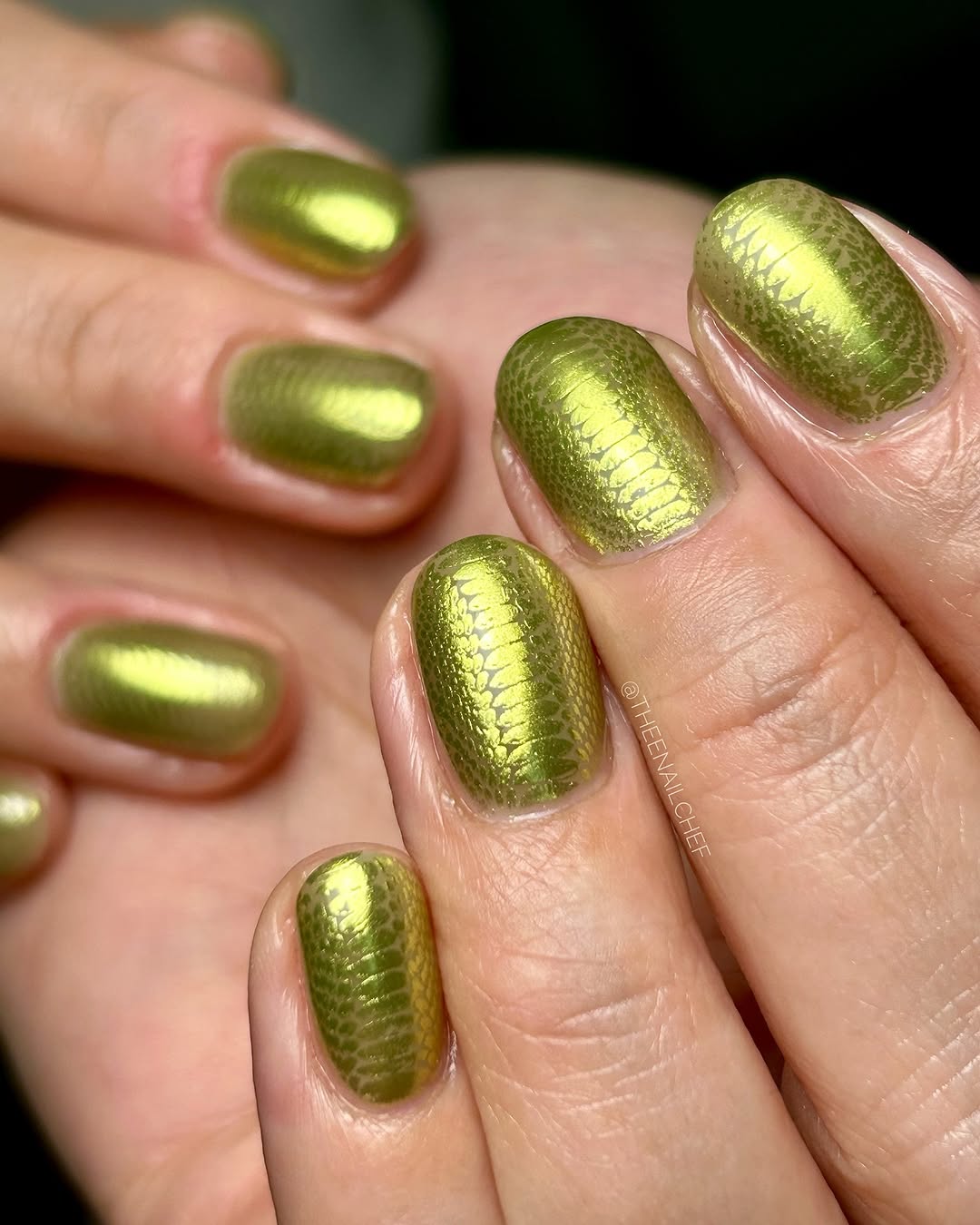 Close up of hand with detailed green nail art