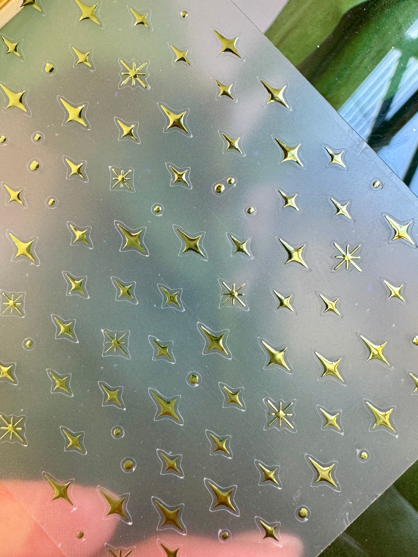 Sheet of star-shaped stickers with a greenish tint