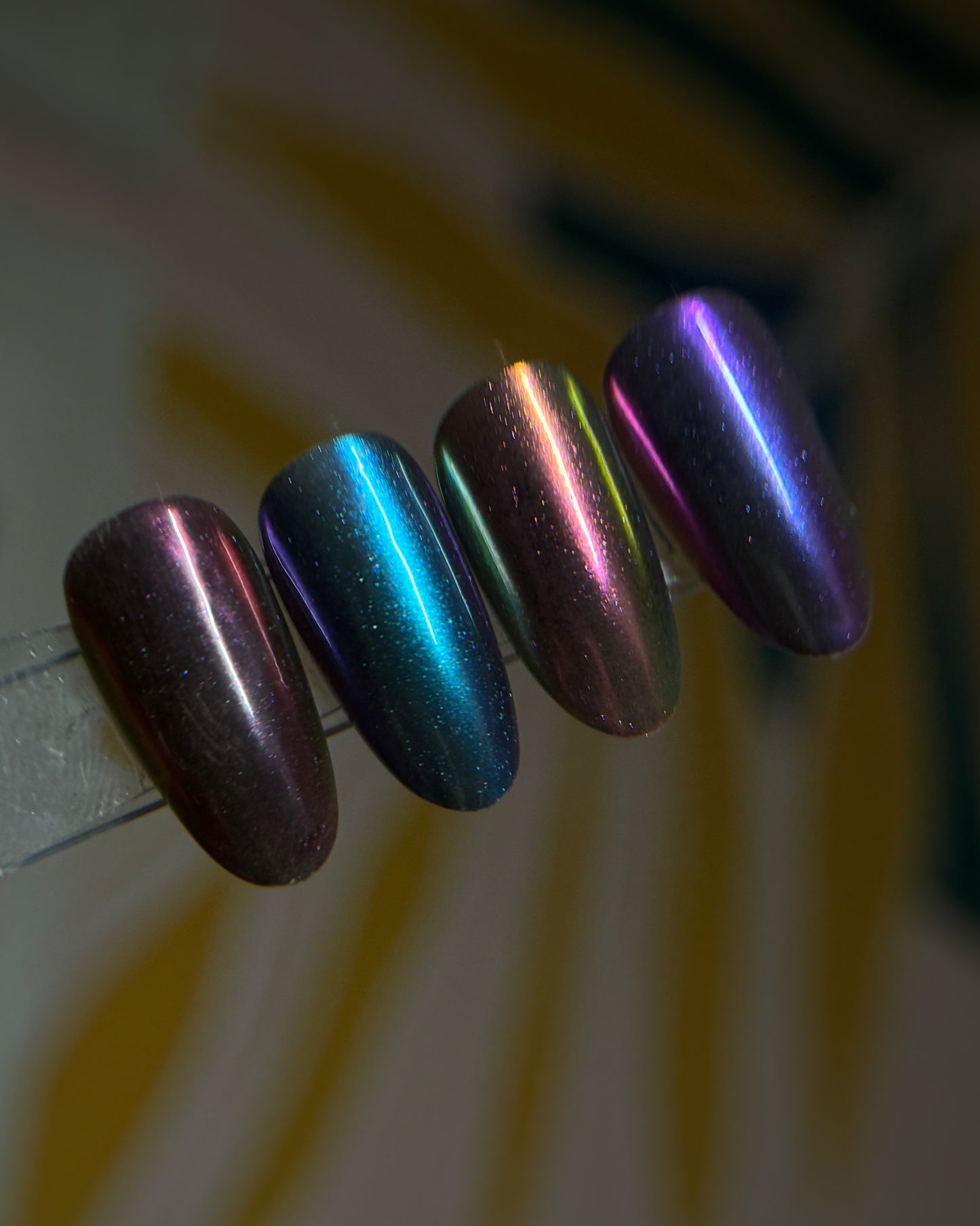 Close up of decorated nail tips against a blurred background