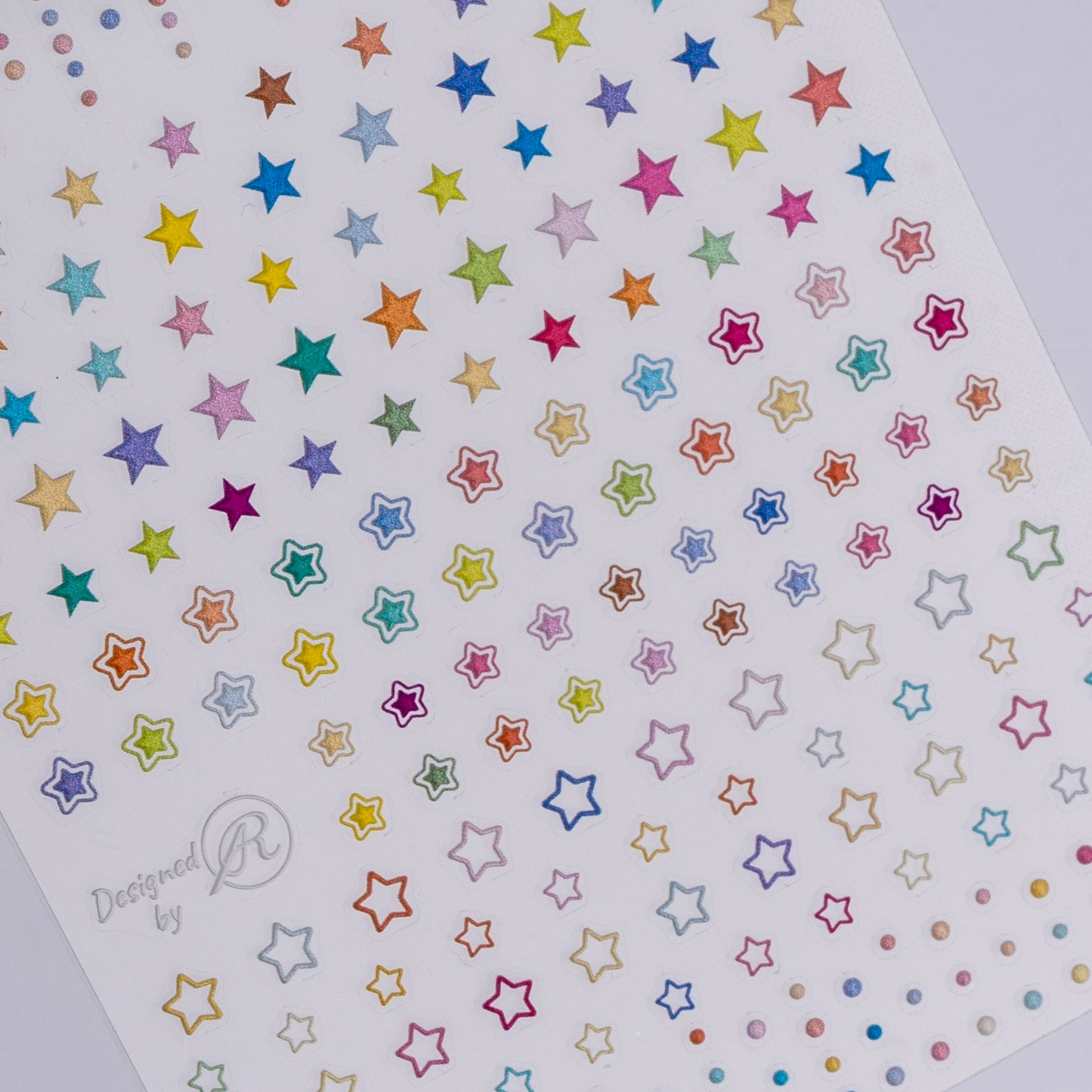 Sheet of colorful star-shaped stickers on a white background