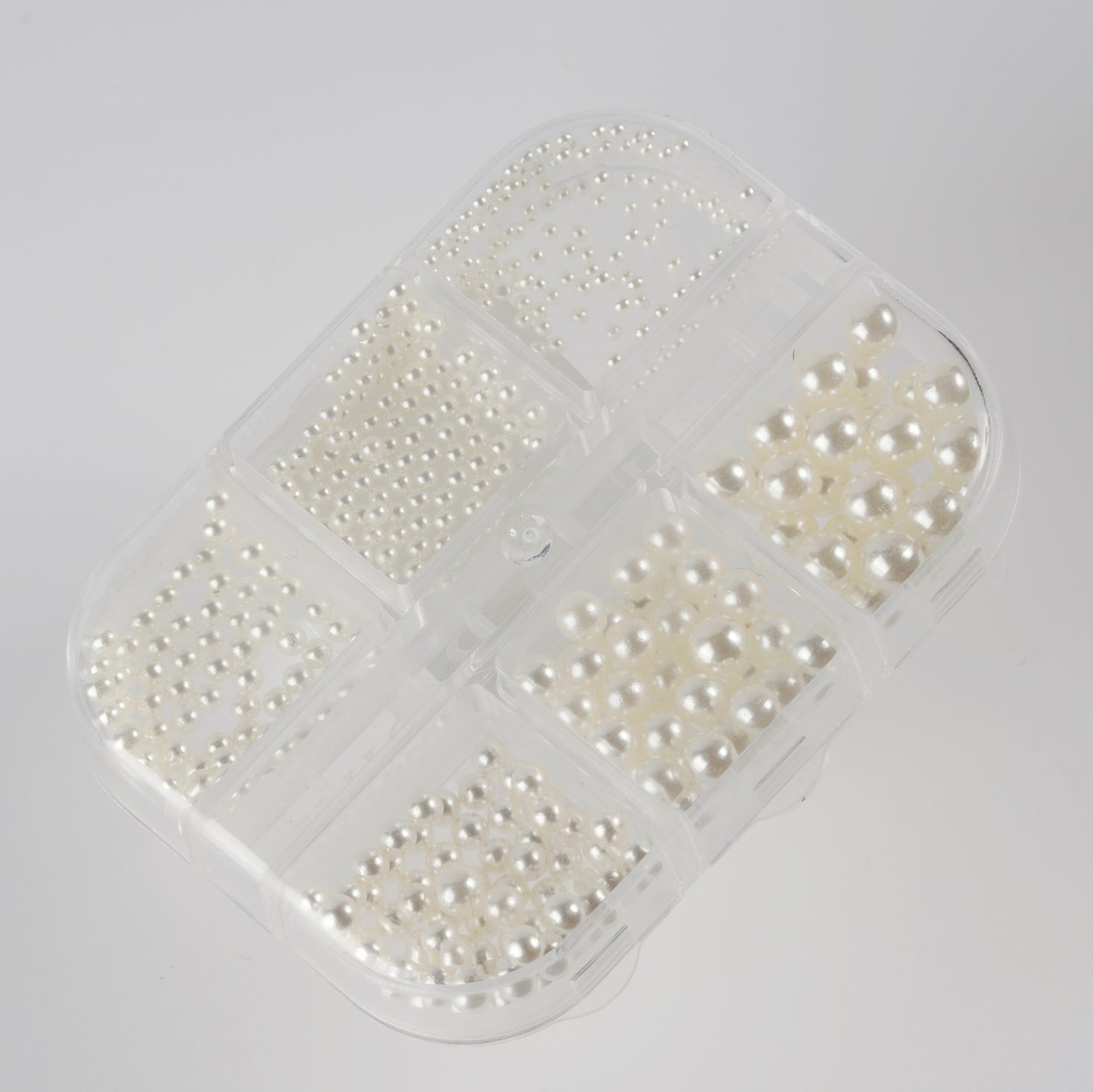 Clear case with ivory pearls on white background.