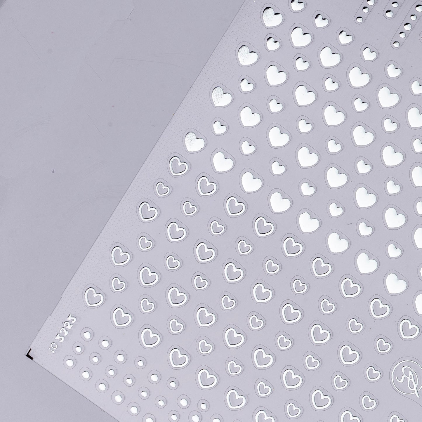 Detail view of nail decal sheet on light background.