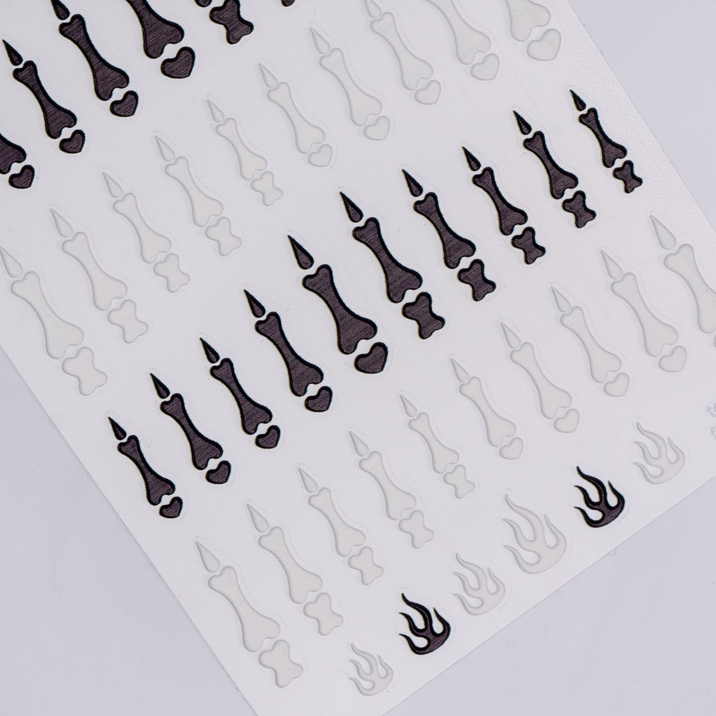 Sheet of black and white nail art stickers on a white background
