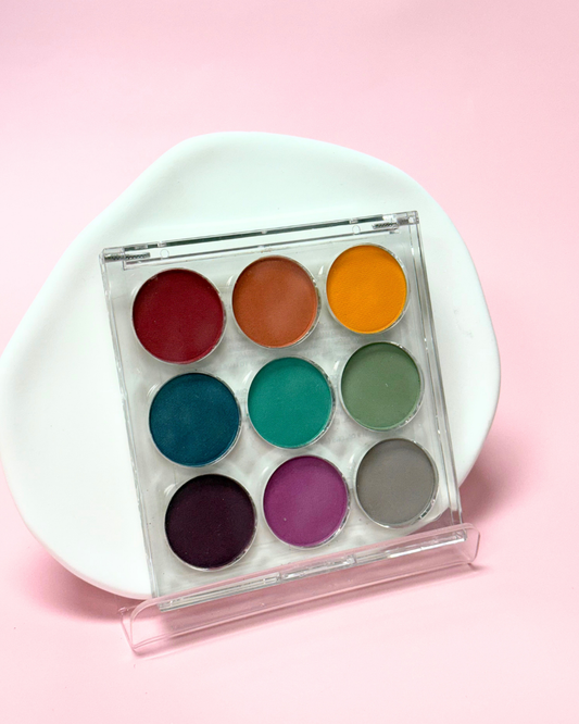 Colorful gradient palette on a white plate with a pink background