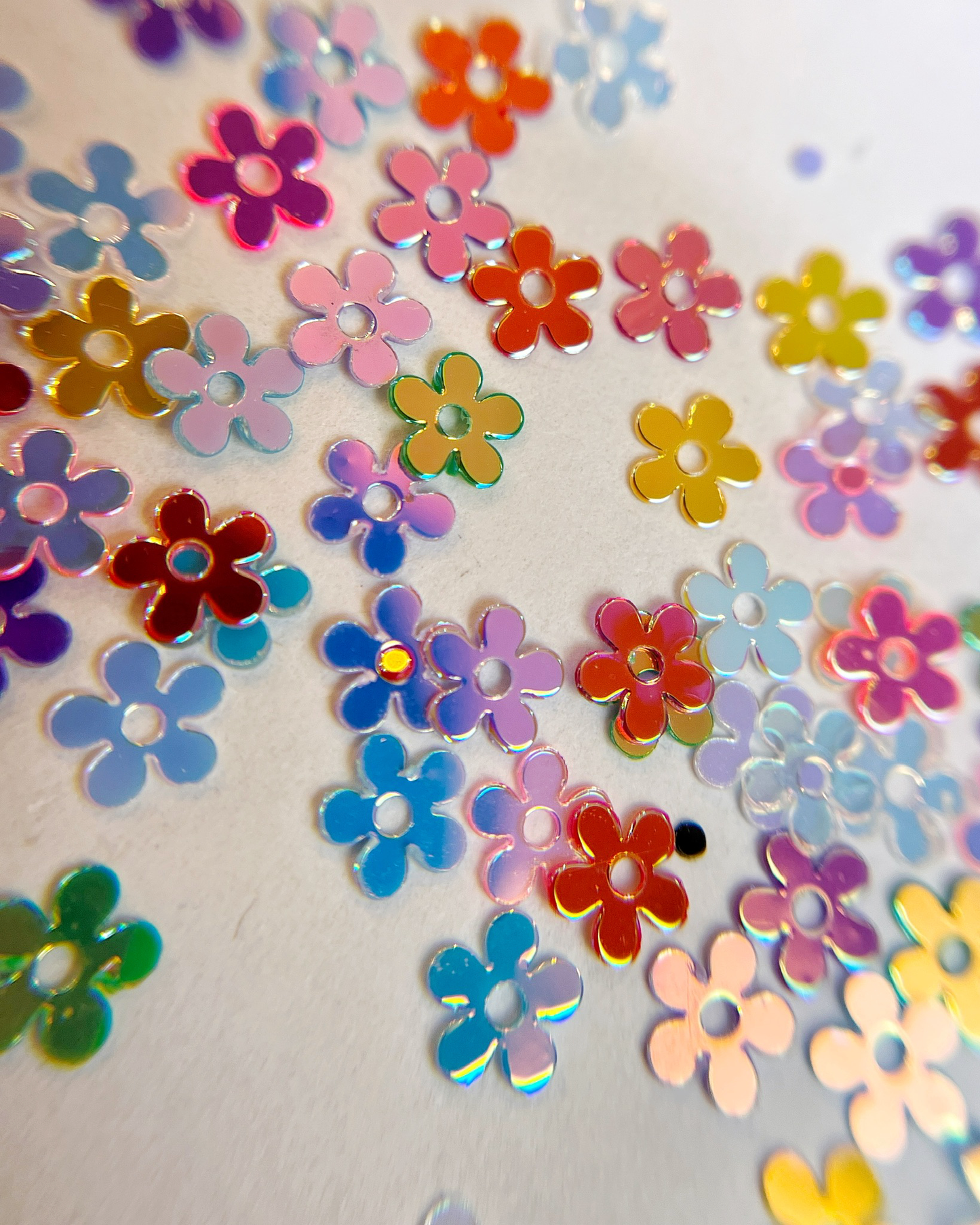 Flower glitter scattered on white background