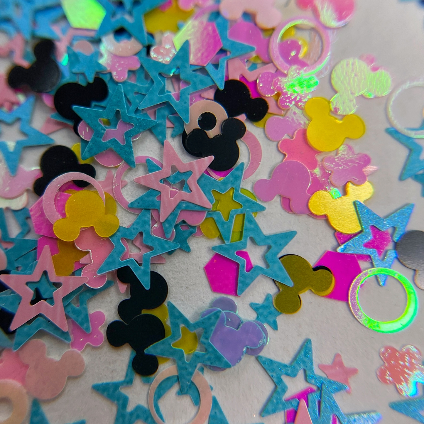 Glitter mix scattered on white background.