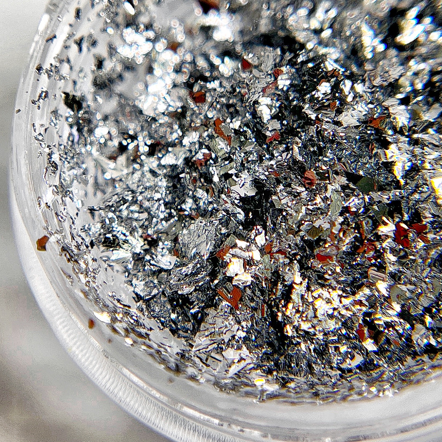 Thin silver foil flakes for nail art.