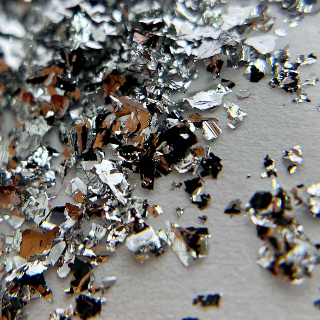 Thin silver foil flakes for nail art.