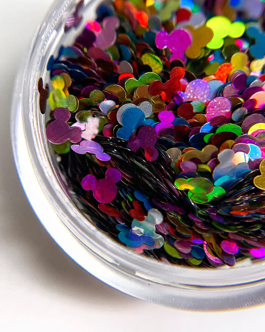Multicolor glitter mix in clear jar on white background.