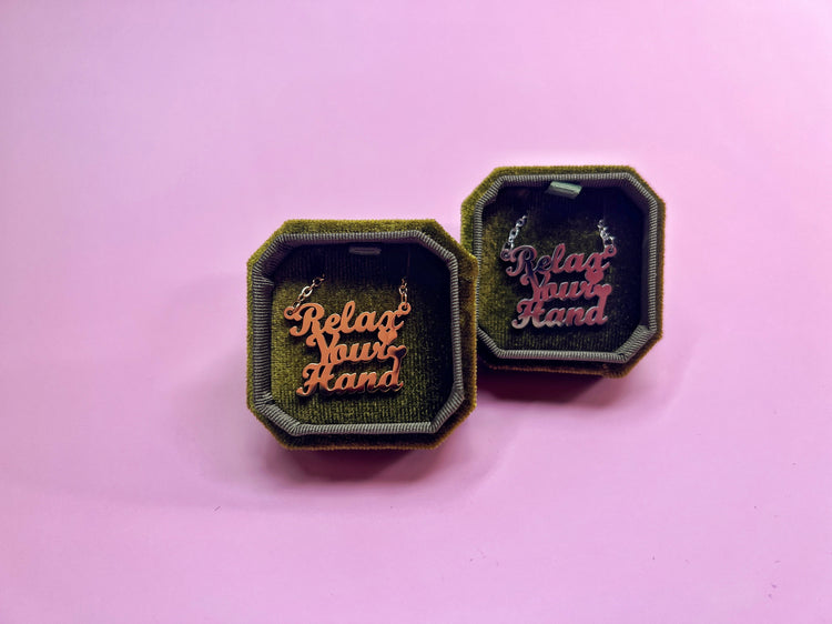Jewelry boxes on pink background.