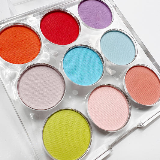 Multicolor pigment palette in clear palette on white background, 