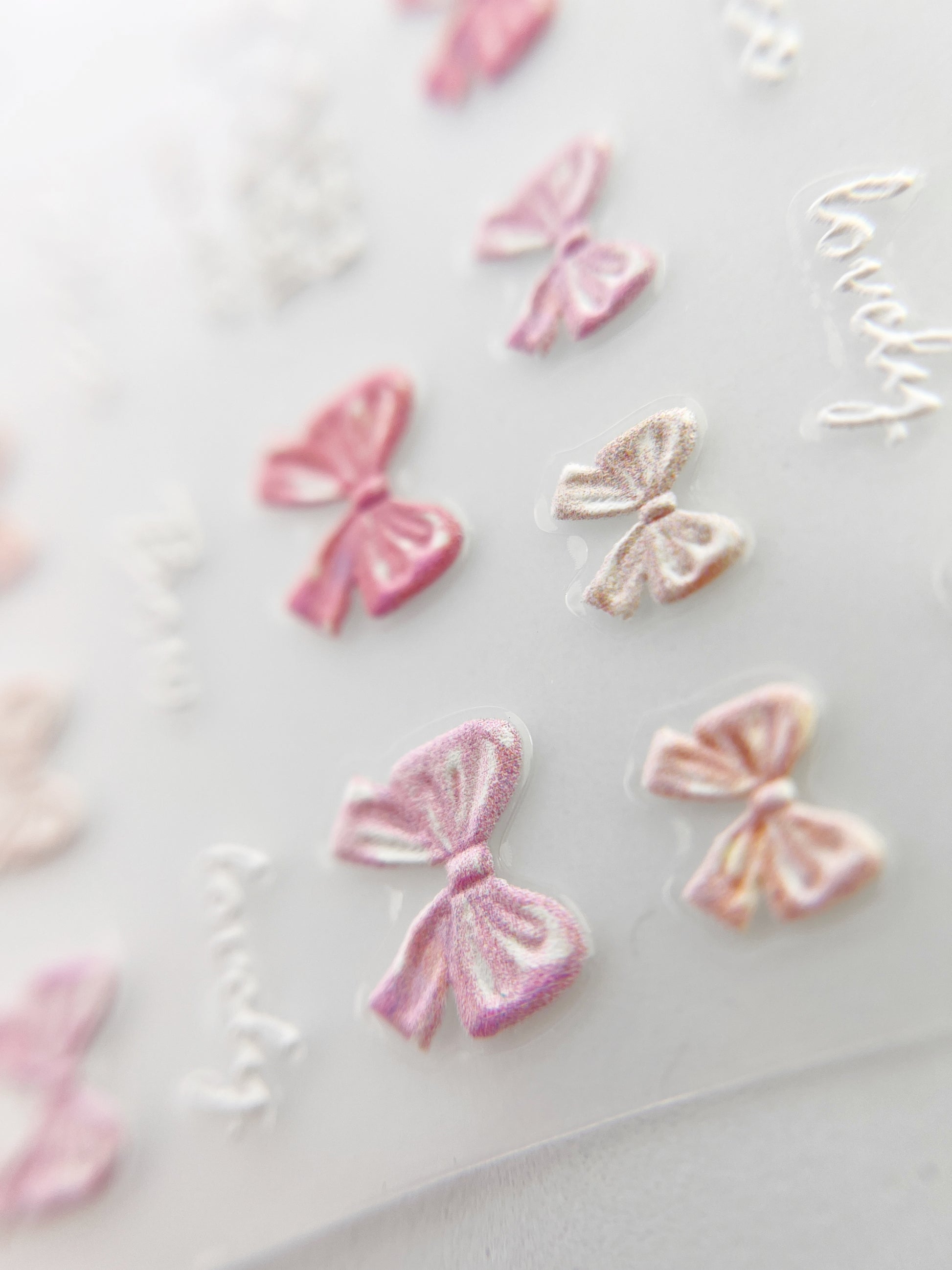 Pink and peach bow embossed nail stickers. 