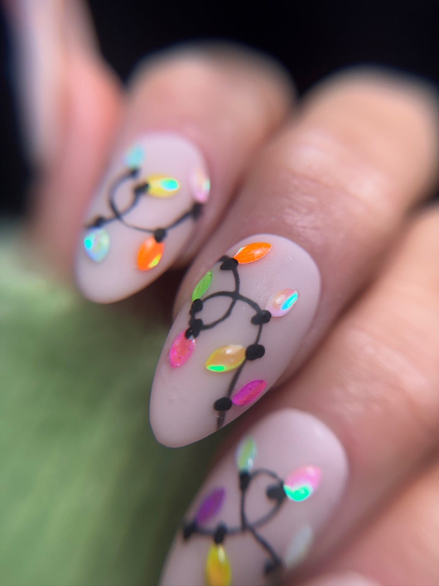 Nails with colorful light bulb design on a blurred background