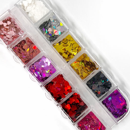 Multi-Size Heart-Shaped Glitter Mix in 12-Grid Palette - Classic Colorway Featuring Metallic Gold, Reds, Pinks, and Neutral Holographic Colors.