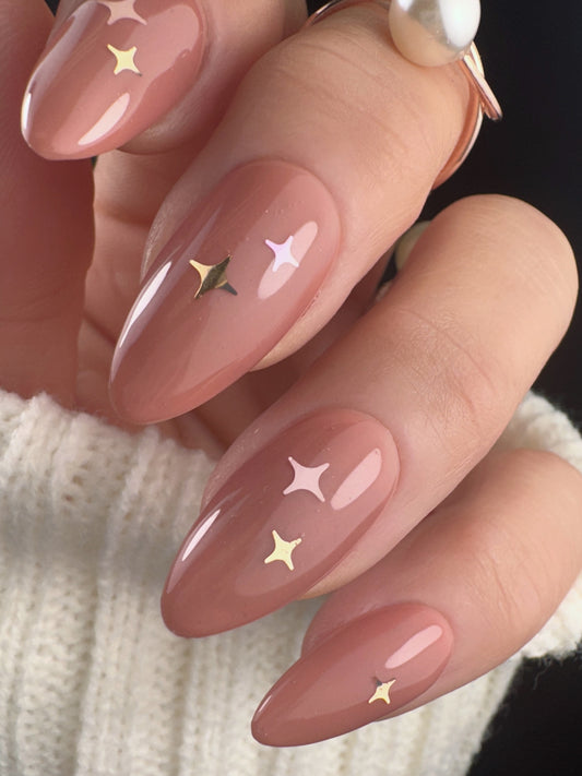 Nails with star designs on a neutral background