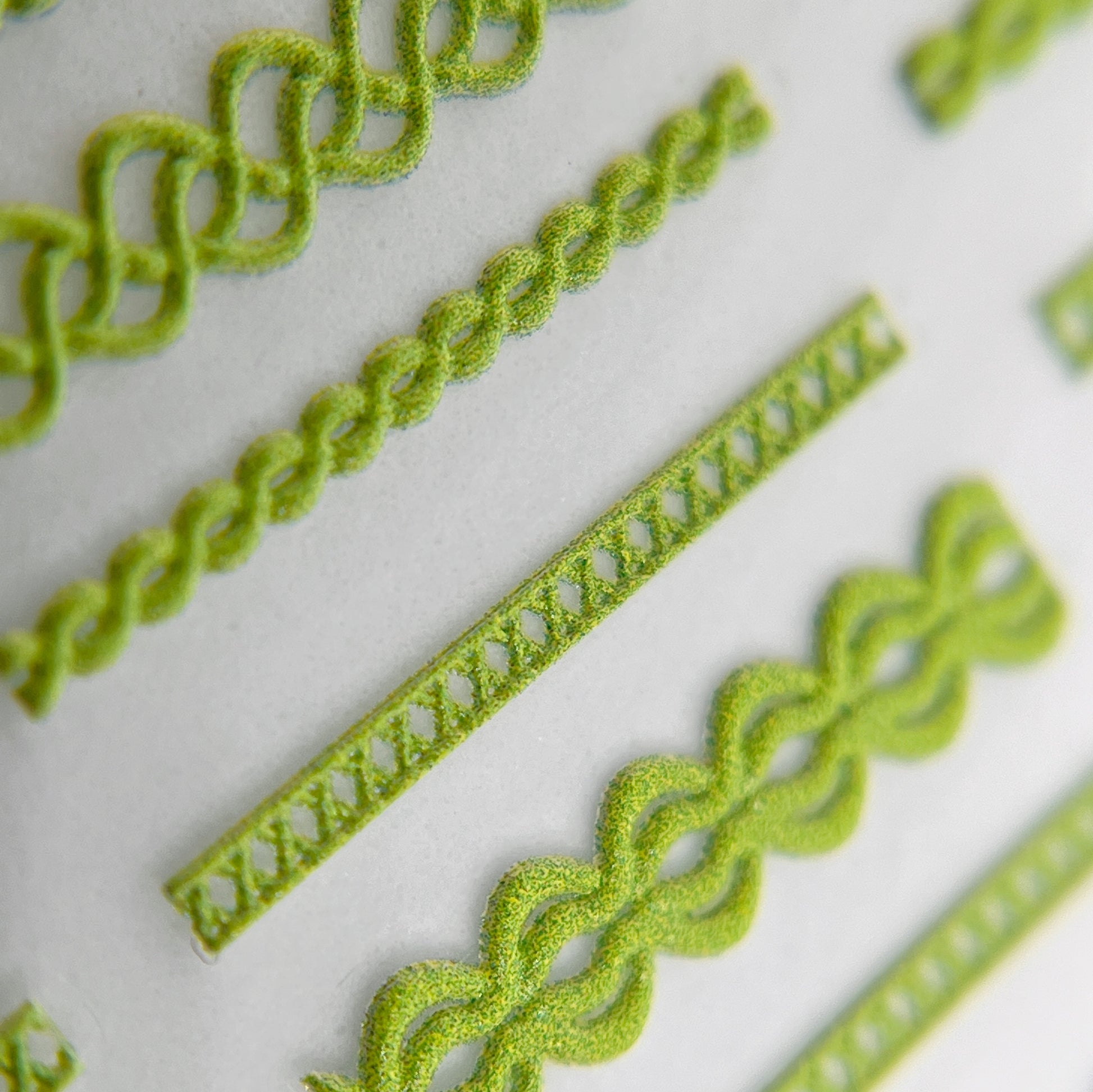 Close-Up of Textured Trim Nail Stickers in Green - Detailed View of Raised Texture Nail Stickers with Fabric Trim-Inspired Design.