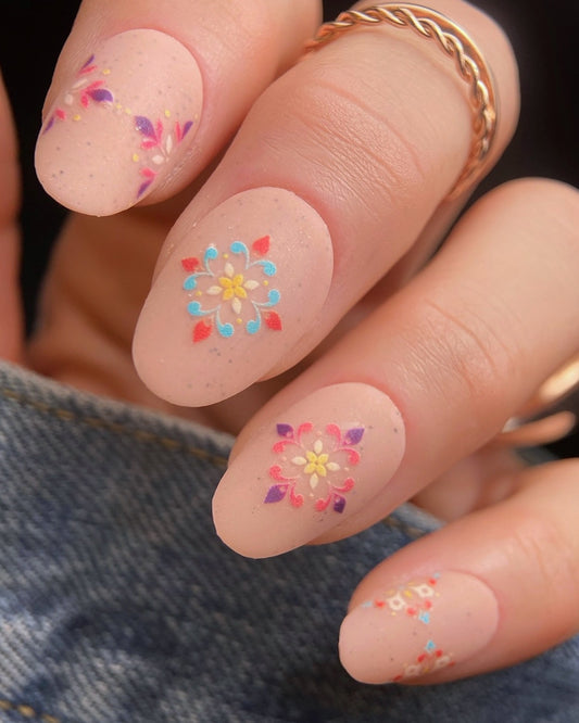 Nails with colorful floral designs on a light background