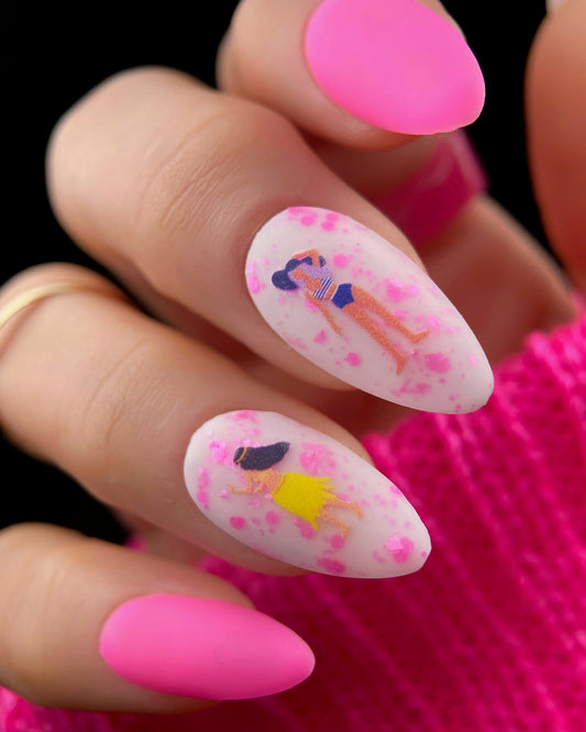 Nails with cartoon character design and pink accents on a dark background
