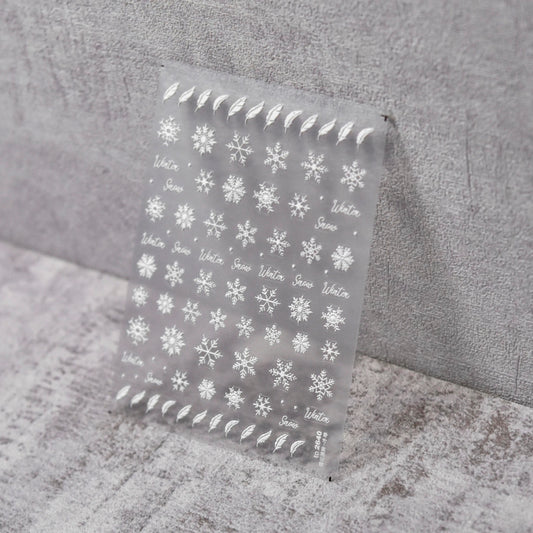 Feathers & Flakes Nail Stickers - Raised Texture White Snowflake and Feather Nail Stickers on Clear Sheet, Gray Textured Background