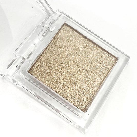 Detail view of  compact with metallic powder on white background. 