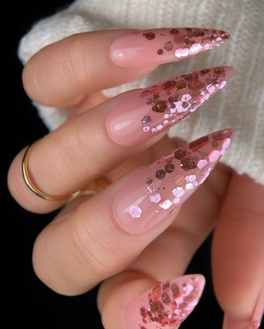 Close-up of a hand with pink glittery nails